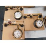 Three retro industrial type wall clocks.