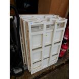 Six stackable folding bookcases, five painted white, each section measuring 96cm high, 70cm wide,