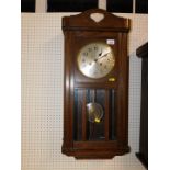 A Continental early 20thC oak cased wall clock, silvered dial bearing Arabic numerals, eight day