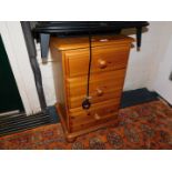 A pine bedside chest of three drawers, 71cm high, 44cm wide, 41cm deep.