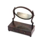 An Edwardian mahogany toilet mirror, the oval swing frame mirror above a rectangular base with two