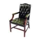 A green leather and mahogany armchair, with button green leather back and overstuffed seat, padded