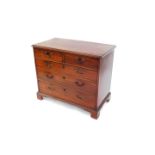 A George III mahogany chest, of two short over three long graduated drawers, raised on bracket feet,