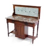 A Victorian mahogany and marble topped washstand, with foliate blue tiled splash back, and single