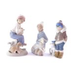 A Lladro porcelain figure of an Eskimo boy with a Polar Bear cub, 14cm high., a kneeling figure of a