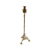 A Victorian brass standard oil lamp, raised on three cast legs, on circular feet, 134cm high.