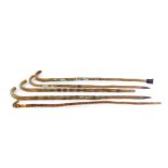 Four German Alpine walking sticks, bearing badges of German towns, together with an ash stick,