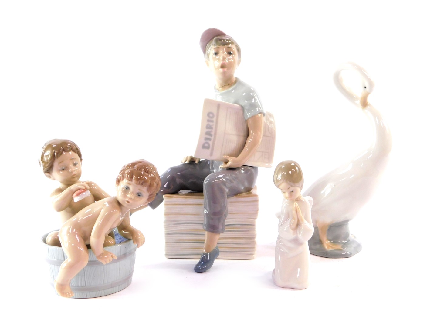 A Lladro porcelain figure modelled as two children in a bathtub, together with a Nao porcelain