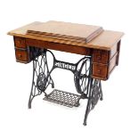 Withdrawn pre-sale by executors- A Singer oak table cased treadle sewing machine,