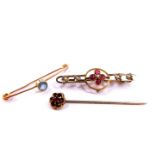 A 9ct gold and aquamarine pin, Victorian garnet and seed pearl set brooch in yellow metal, and a 9ct