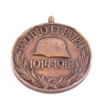An Austro Hungarian WWI war medal, obverse a helmet and 1914-1918 'Pro Deo a et Patri', reverse