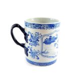 A Chinese blue and white tankard, with double strap handle, decorated with a landscape reserve,