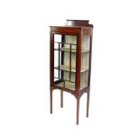An Edwardian mahogany and line inlaid display cabinet, with glazed sides and single door opening
