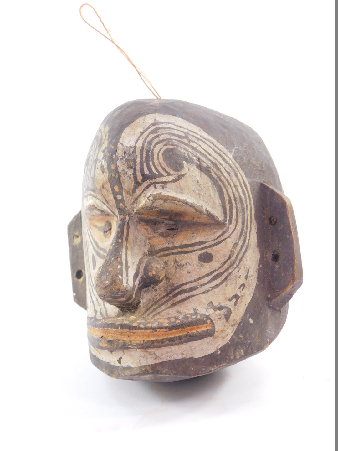 A Papua New Guinea Sepik tribal carved wooden bust, with shell inset eyes and painted facial