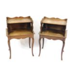 A pair of French oak two tier bedside tables, raised on cabriole legs, 74cm high, 50cm wide, 35cm