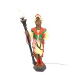 A 20thC plaster figural torchere modelled as a Blackamoor, raised on an hexagonal base, 139cm high.