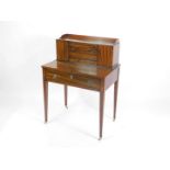 A French Empire style rosewood mahogany and ebonised bonheur du jour, the three sided galleried