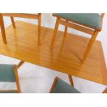 A Donald Gomme G-Plan 1950's light oak and beech dining table, the rectangular top raised on a