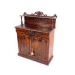 A Victorian flame mahogany chiffonier, the upper super structure with floral and foliate scroll