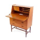 A Danish late 20thC teak bureau, the fall flap opening to reveal drawers, shelves and recesses, over