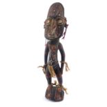A Papua New Guinea Sepik carved wooden figure, modelled in standing pose, with a mask type head,