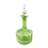 A Mary Gregory type late 19th green glass carafe and stopper, decorated with a boy playing in a