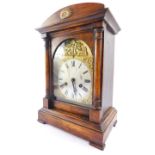 A German early 20thC stained pine mantel clock, brass break arch dial, silvered face bearing Roman