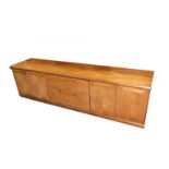 A late 20thC teak sideboard, with a pair of central drawers, flanked by two pairs of cupboard doors,