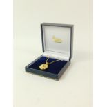 An 18ct gold oval pendant locket, floral engraved, on an 18ct gold neck chain, 18.0g.