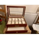 A quality rosewood finish watch / jewellery box, with glazed lid and individual padded