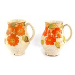 A pair of Arthur Wood 1930's pottery jugs, painted with flowers and spider's webs, no 3123,