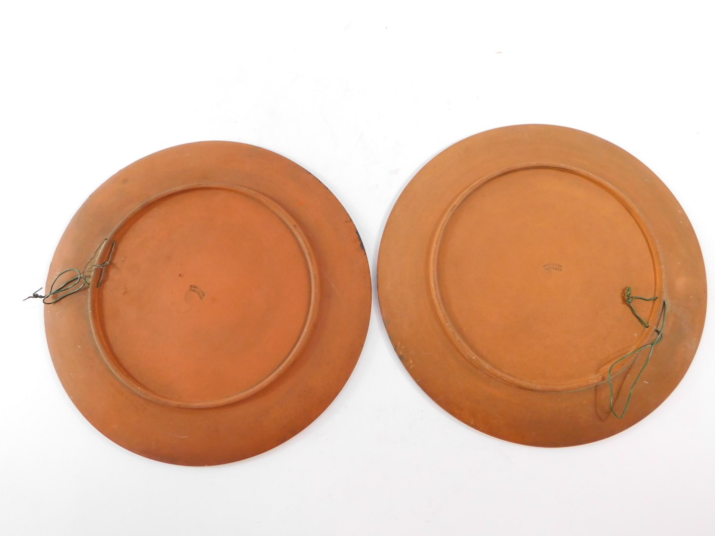 A pair of Watcombe late 19thC terracotta plates, painted with a harvesting scene and winter - Bild 2 aus 3