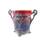 A Continental Art Nouveau pottery and pewter twin handled jardiniere, with a red to green glaze,