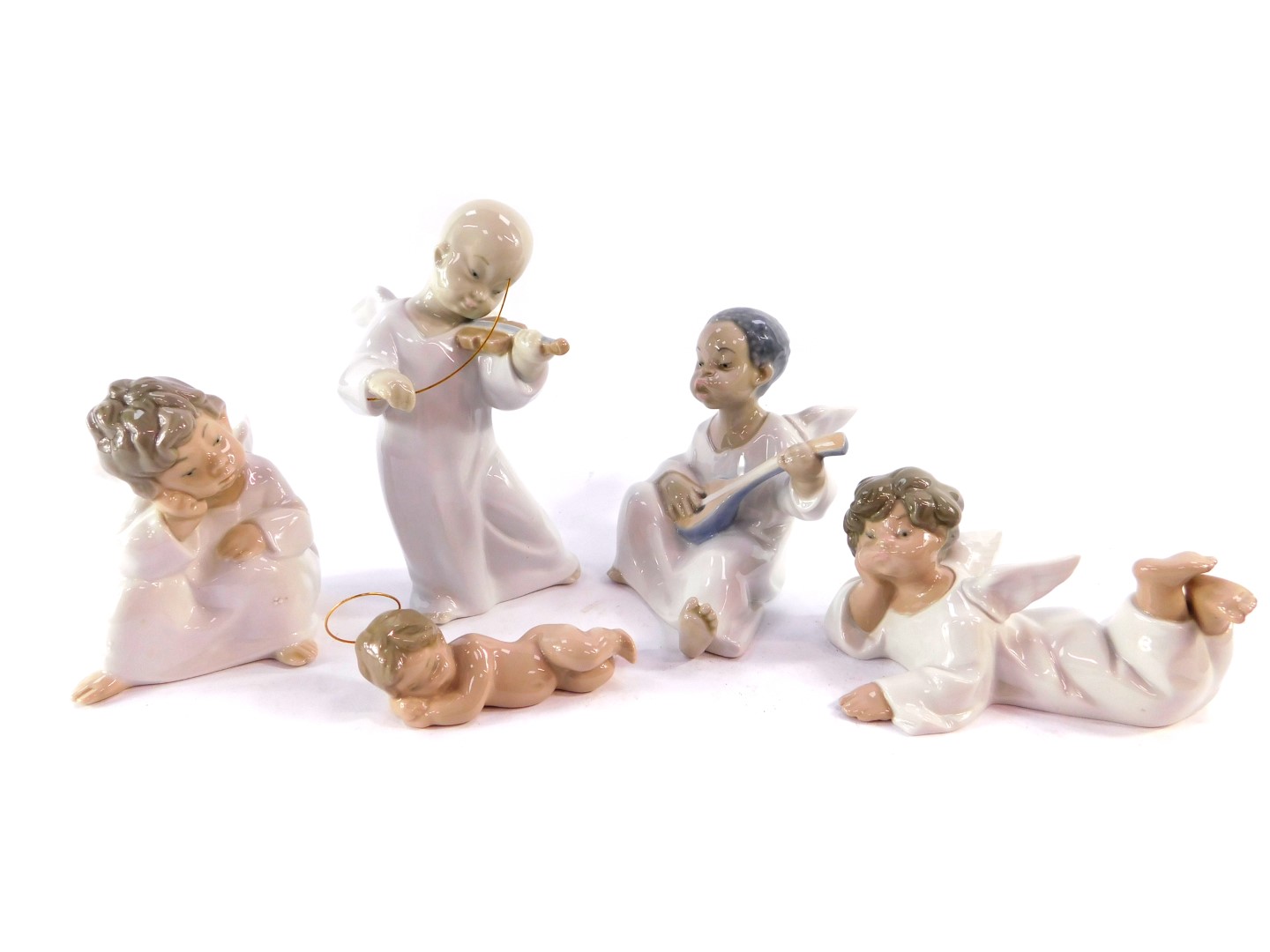 Four Lladro porcelain figures modelled as cherubs, two modelled in contemplation, one playing a