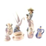 A group of Lladro bisque porcelain ornaments, comprising a bell, three vases and a jug and cover,