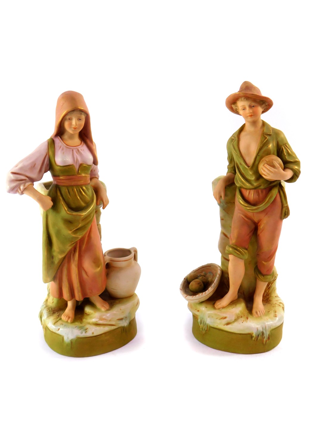 A pair of Royal Dux blush porcelain figural spill vases, modelled as a boy with fruit and girl