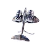 A 1950's chrome aeroplane cruet set, wings mounted with the Arms the City of London, 12cm high.