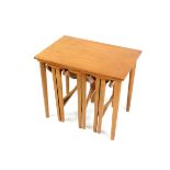 A vintage teak quartetto of occasional tables, the largest table with rectangular top, raised on