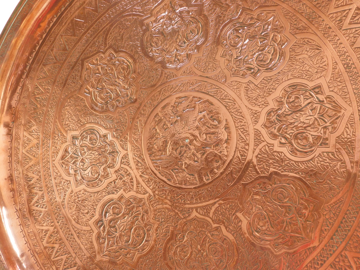 An Indian copper tray, engraved centrally with an Indian Prince on horse back spearing a lion, - Bild 2 aus 3