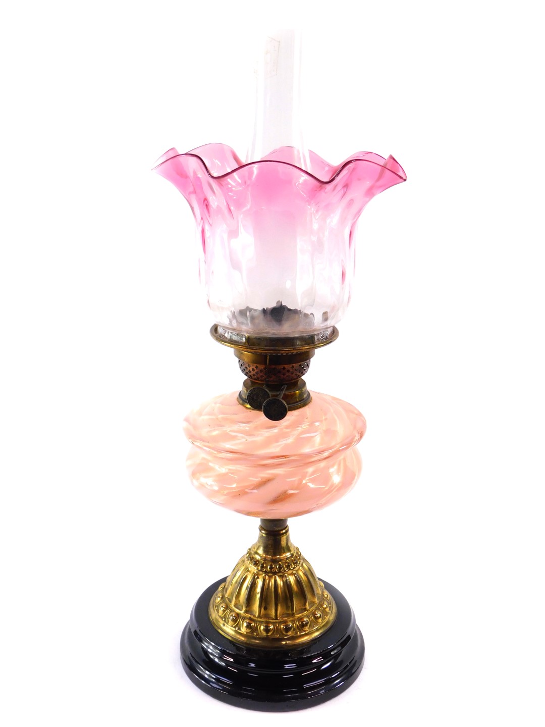 A Duplex early 20thC brass oil lamp, with a pink clear and pearlescent glass reservoir, glass