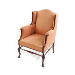 A late Victorian mahogany and inlaid wing armchair, upholstered in patterned salmon pink draylon,