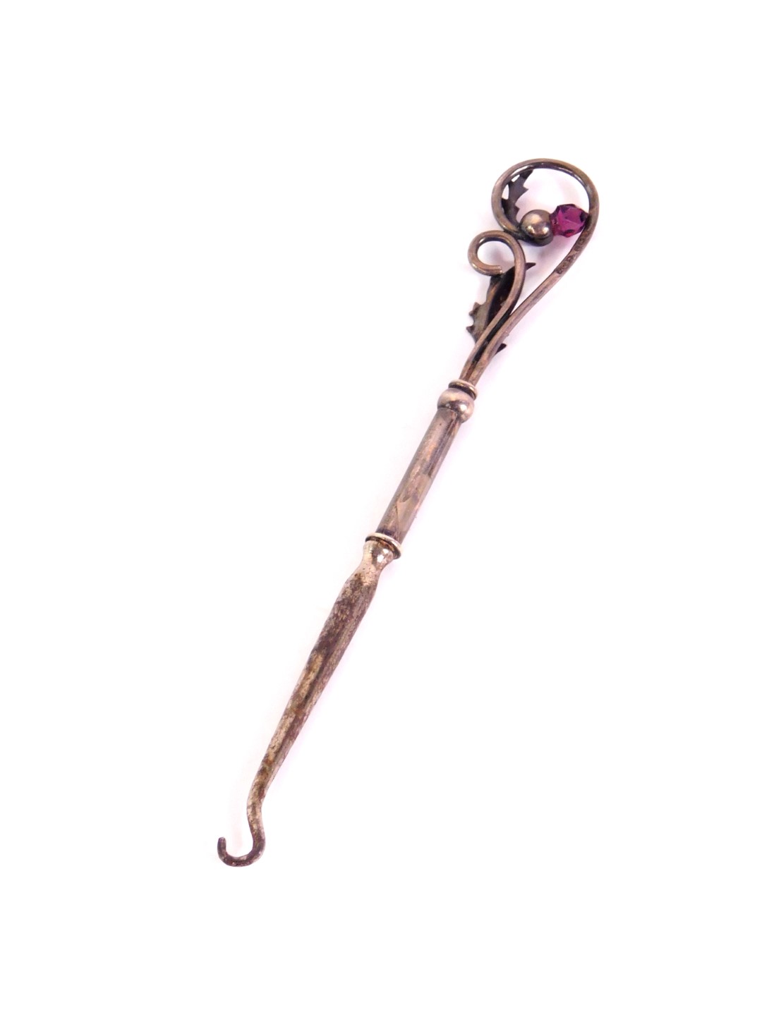 Withdrawn pre-sale by executors-An Edward VII silver button hook,