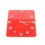 A Karlsson square red glass wall clock, bearing Arabic numerals, with battery operated Quartz