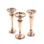 A pair of George V loaded silver posy vases, of trumpet form, Sheffield 1915, together with a