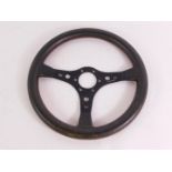 An Irmscher Opal / Vauxhall three spoke steering wheel, leather bound, serial no E1 / 0270503, 35.