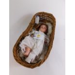 A Huebach Koppelsdorf bisque head doll, no 267.1, 37cm high., together with a wicker doll's cot,