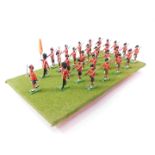 A set of Britains Scots Guards, board mounted. (28)