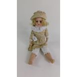A German early 20thC bisque head doll, unmarked, modelled with brown closing eyes, open mouth,