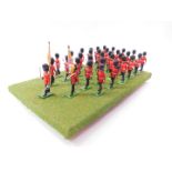 A set of Britains Grenadier Guards, board mounted. (33)