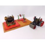 A Mamod steam pump, steam roller, etc., wooden base mounted.